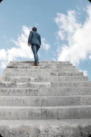 man walking up a stairwell looking up to the sky