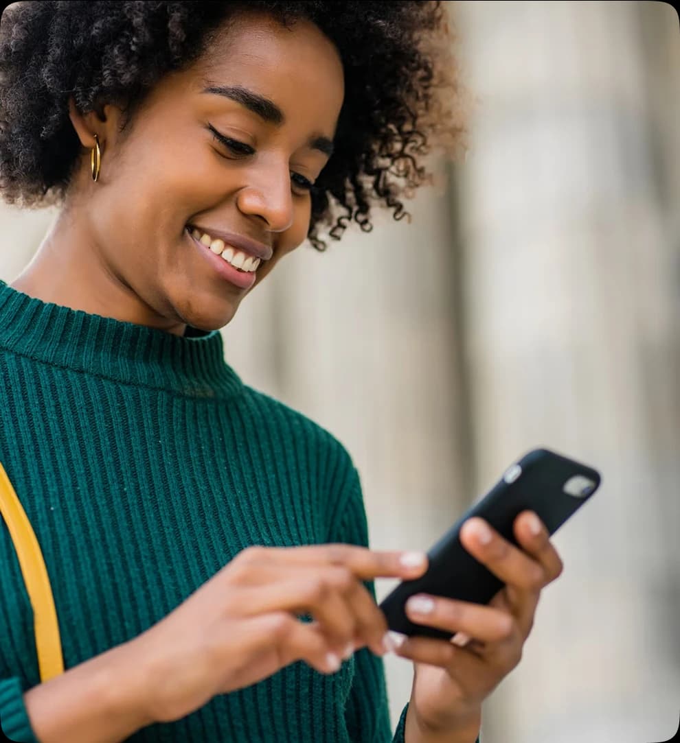woman smiling at her phone