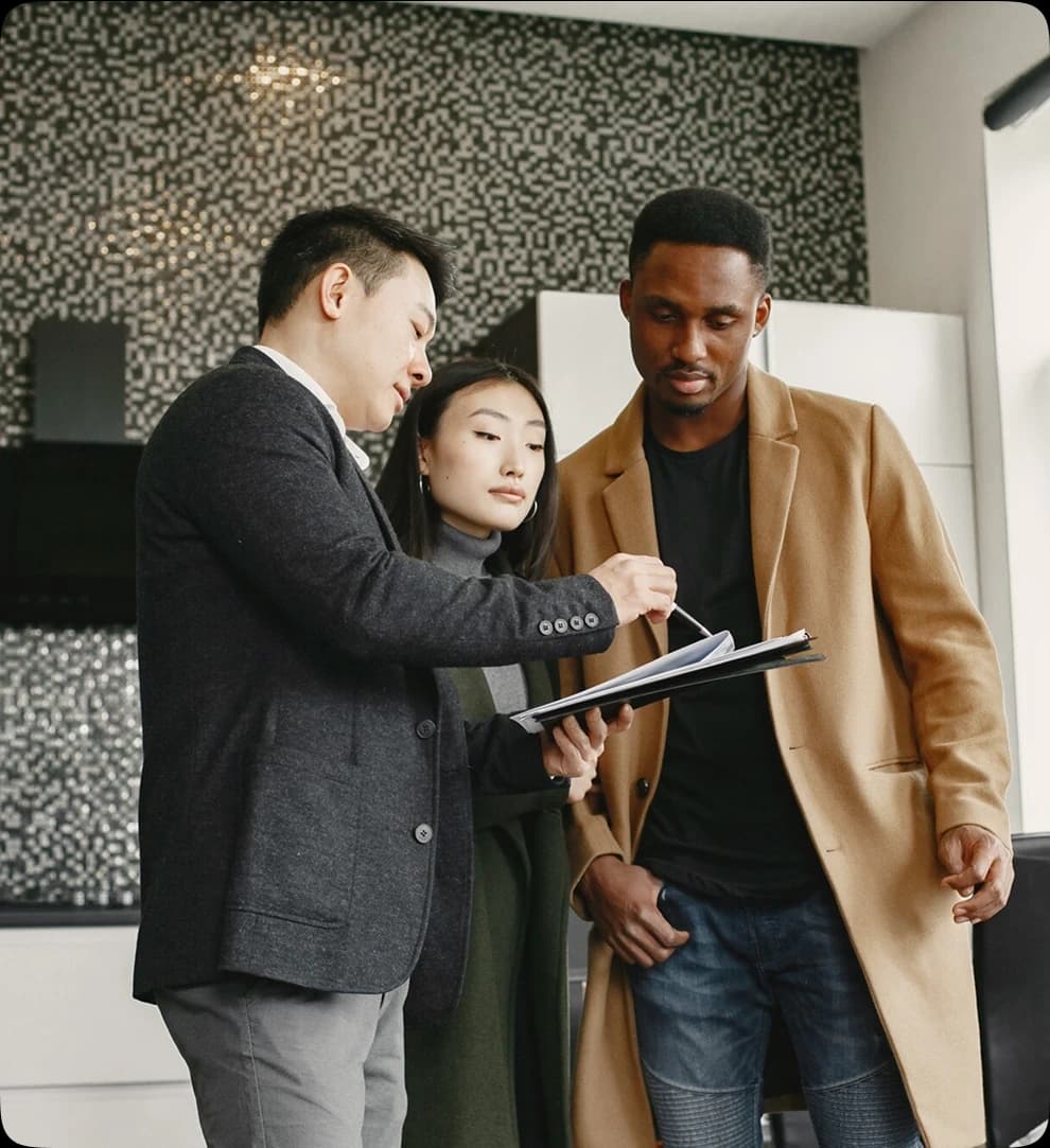 3 professionals looking at a tab screen